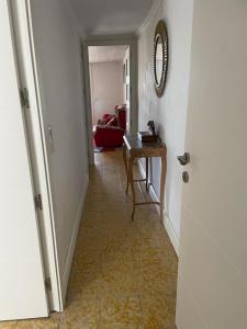 a hallway with a table and a mirror on the wall at Cal Robert in Penellas