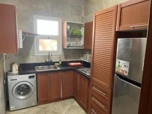 a kitchen with a sink and a washing machine at Amwaj amazing see view in Marsa Matruh