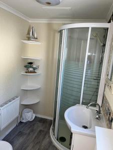 a bathroom with a shower and a sink at Marsh Farm Holiday Park in Great Yarmouth