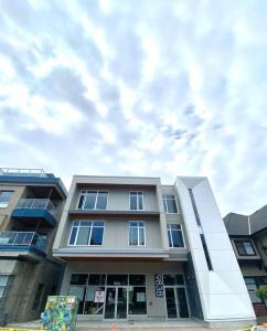 a tall building with a cloudy sky in the background at Lovely Brand New Suite in Sidney