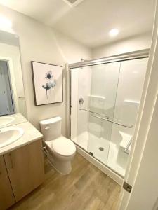 a bathroom with a shower and a toilet and a sink at Lovely Brand New Suite in Sidney