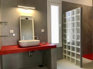 a bathroom with a sink and a mirror at Kokkali Beachfront Villa Leros in Gourna