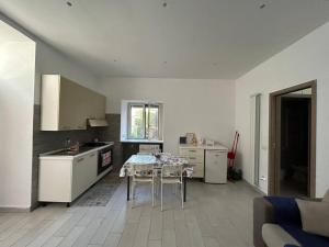 a kitchen with a table and chairs in a room at casa Vesuvio in Cercola +4 photos