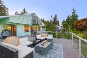 a patio with couches and a grill and a house at Views, Seclusion, Cozy Island Comfort in Camano