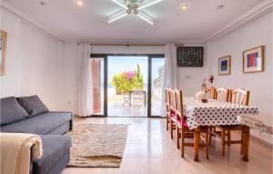 a living room with a table and a couch at Lovely Home In Santa Pola De Lest With House Sea View in Gran Alacant