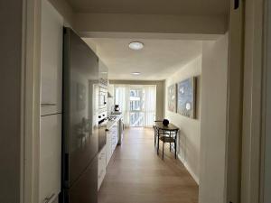 a kitchen with a hallway with a table and a kitchen sidx sidx sidx at Primera Linea Playa de LEVANTE in Benidorm