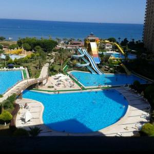 a view of a water park with a roller coaster at liparis 3 Agritourism & Mediterranean Cuisine , holiday, aquapark , beach in Erdemli