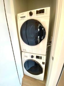 a washer and dryer sitting in a room at Lovely Brand New Suite in Sidney