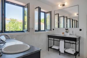 a bathroom with a sink and a large mirror at Casa da Marechal - Boutique Hotel by Oporto Collection - Adults Only in Porto
