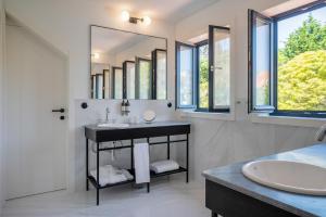 a bathroom with a sink and a large mirror at Casa da Marechal - Boutique Hotel by Oporto Collection - Adults Only in Porto
