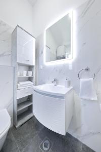 a white bathroom with a sink and a toilet at Kuca za odmor Davorka in Lukoran