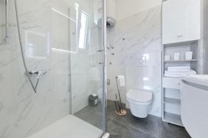 a white bathroom with a shower and a toilet at Kuca za odmor Davorka in Lukoran +14 photos