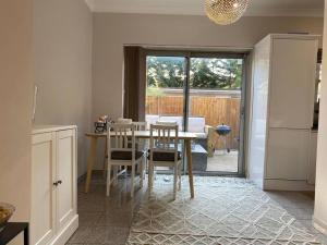 a kitchen with a table and chairs and a dining room at cheviot 2 bed in London