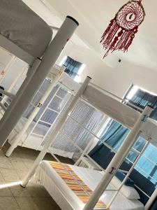 a bunk bed in a hospital room with a chandelier at Vive Alegria Hostel in Puerto Vallarta