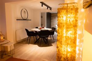 a dining room with a table and chairs at Chez Blanche in Waterloo