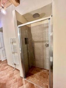 a shower with a glass door in a bathroom at Sangi Chianti Vacations in Poggibonsi