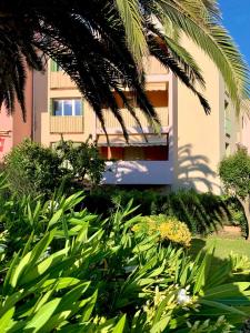 a building with a lot of plants in front of it at Luxury Apartment St-Tropez/ 10mn walk to center. in Saint-Tropez