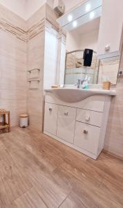 a bathroom with a sink and a mirror at Appartamento Sofia a Genova in Genova