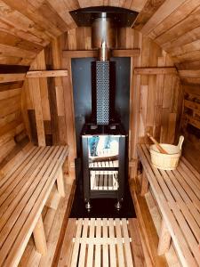 an inside view of a wooden sauna with a stove at Kabuto Villas ー古民家ステイー 