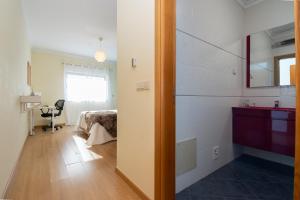 a hallway with a room with a bed and a table at Apartamento Mãe Soberana in Loulé +27 photos