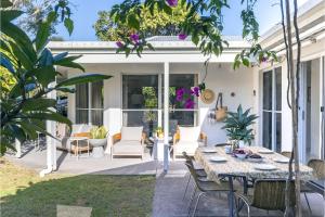 a patio with a table and chairs at Celeste, 26 Bonito Street - Tranquil, Stylish & Pet friendly in Corlette