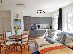a living room with a couch and a table at Musashi Apartment 3 in Weimar
