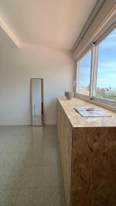 a room with a counter and a large window at VIP Alfaz del Pi in L’Alfàs del Pi