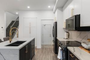 a kitchen with black appliances and white walls at Jewel of Blue Mountain in Blue Mountains