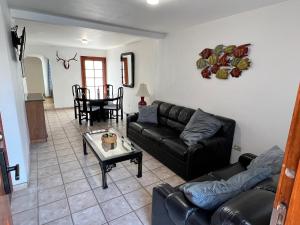 a living room with a couch and a table at Casa Mediterraneo in Ensenada