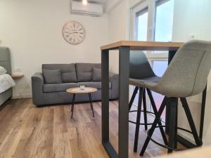 a living room with a table and a couch at Apartment Mara&Padrona in Zadar