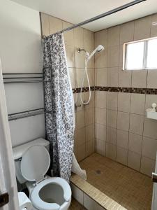 a bathroom with a toilet and a shower at Casa Mediterraneo in Ensenada