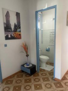 a bathroom with a toilet and a vase at La maison de la plage in Sainte-Luce