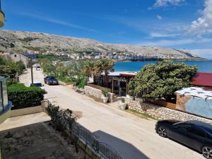 a street with a view of a city and the ocean at Villa Gabriel in Pag