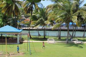 two children playing on a swing set in a park at The Vue at Dos Marina in Fajardo