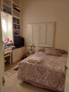 a bedroom with a bed and a desk and a television at CATmosphere 2 in Las Vegas