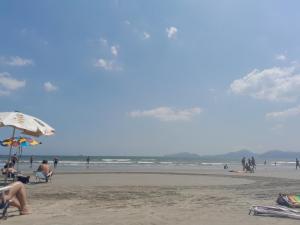 a group of people sitting on the beach at Beira-mar in Santos