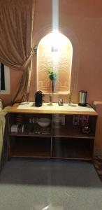 a bedroom with a vanity with a sink and a mirror at Villa plage tiguert in Agadir