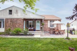 a brick house with a patio with a table and chairs at Renovated, Quiet, and 1/2 Mile to BEACH in Cape May