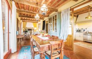 a kitchen with a wooden table and a dining room at 4 Bedroom Beautiful Home In Rapolano Terme Si in Rigomagno