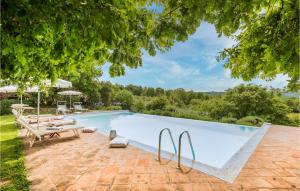 a large swimming pool with a picnic table and a bench at 4 Bedroom Beautiful Home In Rapolano Terme Si in Rigomagno