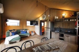 a kitchen and living room in a tiny house at Phillip Island Park Lane Holiday Park in Cowes