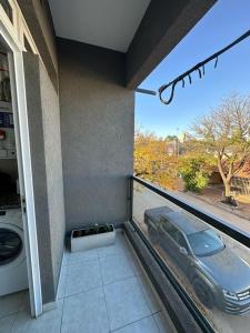 a balcony with a car outside of a house at DON SIMON Apart 8 -departamento nuevo in Esperanza