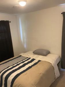 a small bedroom with a bed in a room at Two bedroom flat with fire place in Detroit