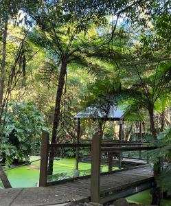 a wooden bridge with a gazebo in a park at The Oasis at One Mile Beach in Nelson Bay