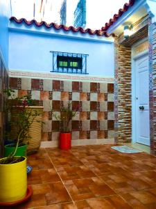 a living room with a tiled wall and a door at Casa murcia in Chefchaouene