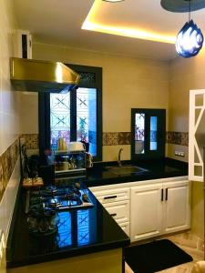 a kitchen with a black counter top and a stove at Casa murcia in Chefchaouene