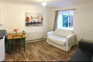 a living room with a white couch and a table at Privite 2 bedrooms flat Canada Water in London