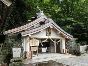a small shrine with a roof on top of it at Breath in Earth in Nagano