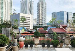 a view of a city with buildings and potted plants at Magabelle Guesthouse in Cebu City