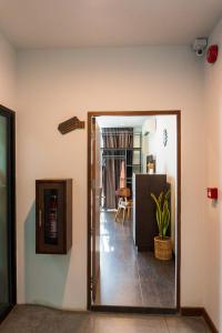 a hallway with a door open to a room with at Wealth Boutique Hotel Chiang Mai in Chiang Mai +220 photos